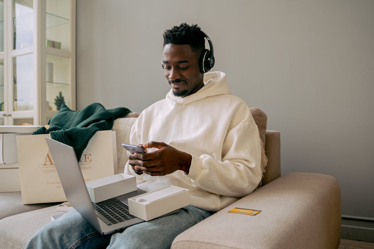 mężczyzna z telefonem i laptopem